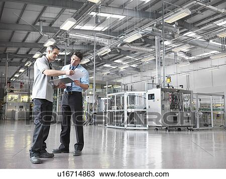Factory workers in bottling plant View Large Photo Image Stock Image - Factory workers in bottling plant. Fotosearch