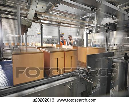 Factory workers in bottling plant View Large Photo Image Stock Image - Factory workers in bottling plant. Fotosearch