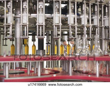 Stock Photo - Factory workers in bottling plant. Fotosearch