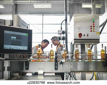 Stock Photo - Factory workers in bottling plant. Fotosearch