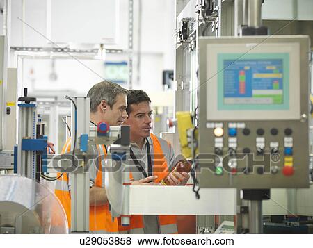 Factory workers in bottling plant View Large Photo Image Stock Photo - Factory workers in bottling plant. Fotosearch