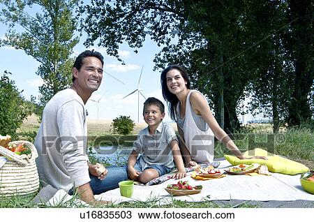 Stock Image - Family having a picnic. Fotosearch