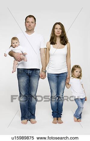 Stock Photography - Family standing hand-in-hand. Fotosearch