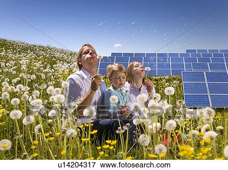 Stock Photo - Father and children with solar panels. Fotosearch
