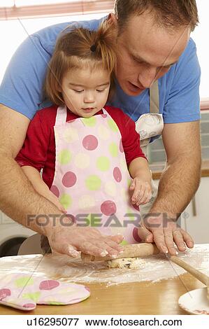 Father and daughter cooking together View Large Photo Image Stock Photo - Father and daughter cooking together. Fotosearch