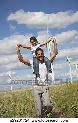 Picture - Father and daughter on a windfarm. Fotosearch