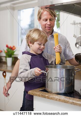 Father and son cooking together View Large Photo Image Stock Photo - Father and son cooking together. Fotosearch