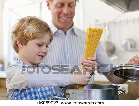 Father and son cooking together View Large Photo Image Stock Photo - Father and son cooking together. Fotosearch