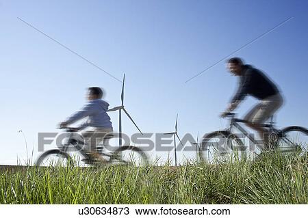 Father and son cycling past a windfarm View Large Photo Image Stock Image - Father and son cycling past a windfarm. Fotosearch
