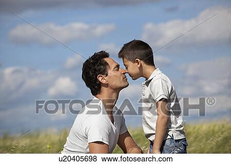 Father and son in a field View Large Photo Image Stock Photo - Father and son in a field. Fotosearch