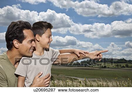Father and son in a field View Large Photo Image Stock Photo - Father and son in a field. Fotosearch