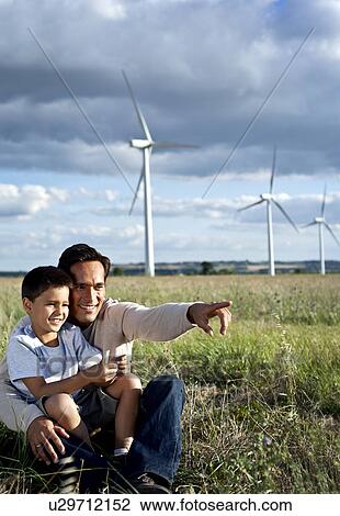 Stock Image - Father and son on a wind farm. Fotosearch
