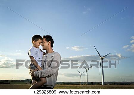 Father and son on a wind farm View Large Photo Image Stock Photo - Father and son on a wind farm. Fotosearch