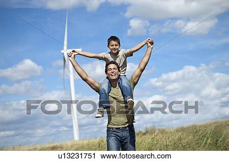 Father and son on a windfarm View Large Photo Image Stock Image - Father and son on a windfarm. Fotosearch