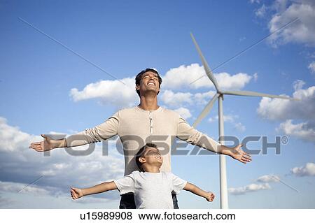 Stock Photo - Father and son on a windfarm. Fotosearch