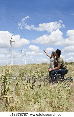 Father and son on a windfarm View Large Photo Image Stock Photo - Father and son on a windfarm. Fotosearch
