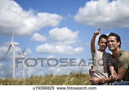 Stock Photo - Father and son on a windfarm. Fotosearch