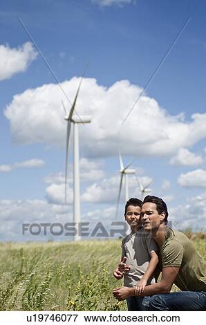 Father and son on a windfarm View Large Photo Image Stock Photo - Father and son on a windfarm. Fotosearch