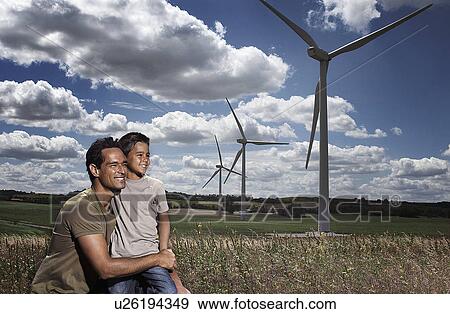 Father and son on a windfarm View Large Photo Image Stock Photo - Father and son on a windfarm. Fotosearch