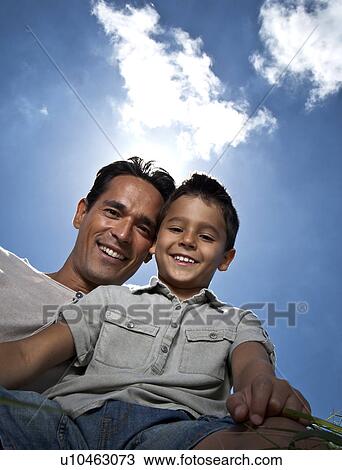 Father and son portrait against blue sky View Large Photo Image Stock Image - Father and son portrait against blue sky. Fotosearch