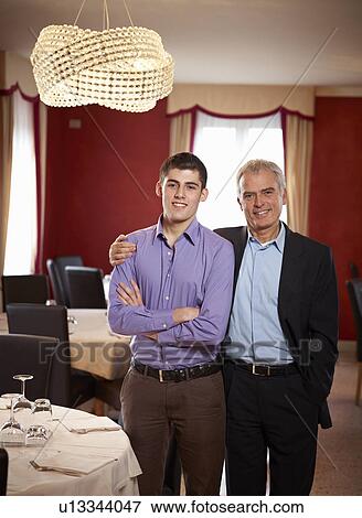 Father and Son share an intimate moment in Family restaurent View Large Photo Image Stock Photo - Father and Son share an intimate moment in Family restaurent. Fotosearch