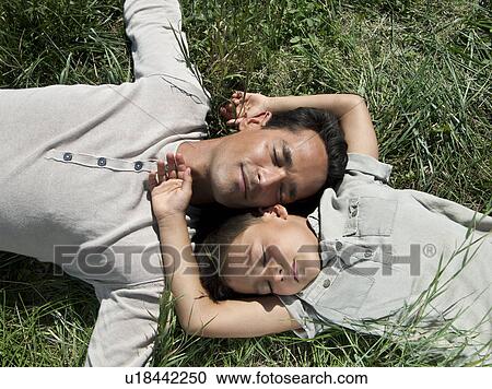 Father and son sleeping in the grass View Large Photo Image Stock Image - Father and son sleeping in the grass. Fotosearch