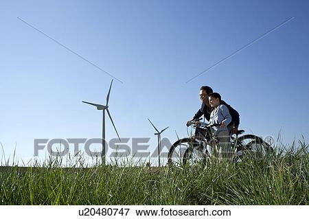 Father and son with bikes by a windfarm View Large Photo Image Stock Photo - Father and son with bikes by a windfarm. Fotosearch