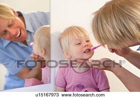 Father brushing toddler daughter’s teeth View Large Photo Image Stock Image - Father brushing toddler daughter’s teeth. Fotosearch