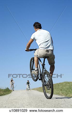 Father with family doing a wheelie View Large Photo Image Stock Photo - Father with family doing a wheelie. Fotosearch