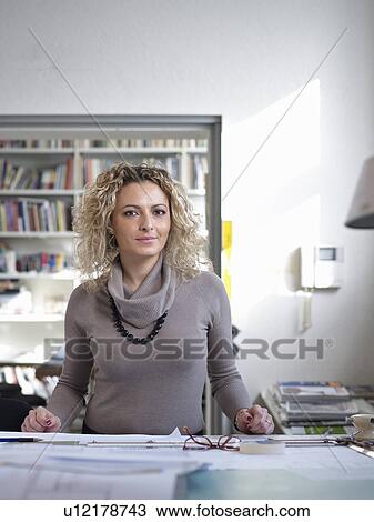 Stock Image - Female Architect taking a moment to rest. Fotosearch