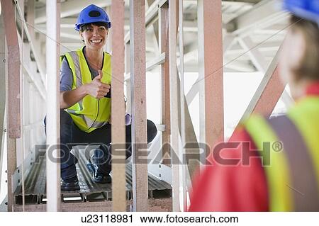 Female architect talkiing to a builder View Large Photo Image Stock Image - Female architect talkiing to a builder. Fotosearch