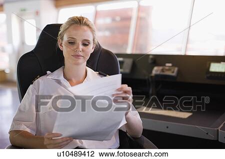 Female captain at work View Large Photo Image Stock Image - Female captain at work. Fotosearch