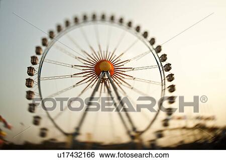 Ferris wheel against blue sky View Large Photo Image Stock Photograph - Ferris wheel against blue sky. Fotosearch