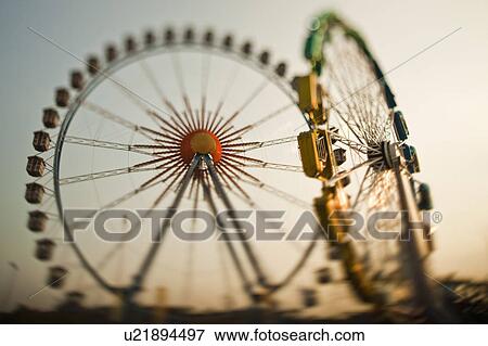 Ferris wheels against blue sky View Large Photo Image Stock Photo - Ferris wheels against blue sky. Fotosearch