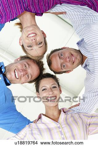 Picture - Four happy business people. Fotosearch