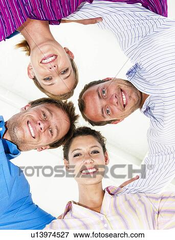 Stock Photo - Four happy business people. Fotosearch