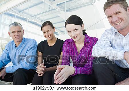 Four happy members of a business team View Large Photo Image Stock Photo - Four happy members of a business team. Fotosearch