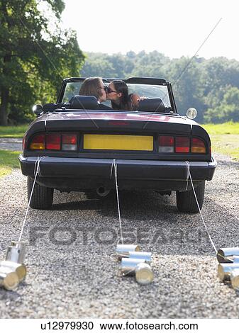 Freshly married couple kissing in car View Large Photo Image Stock Image - Freshly married couple kissing in car. Fotosearch