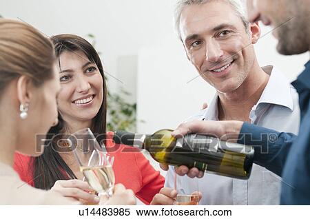 Stock Photography - Friends celebrating together with wine. Fotosearch