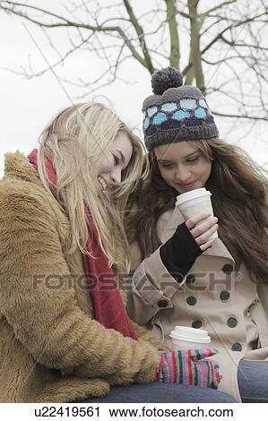Friends having a take away drink View Large Photo Image Stock Image - Friends having a take away drink. Fotosearch