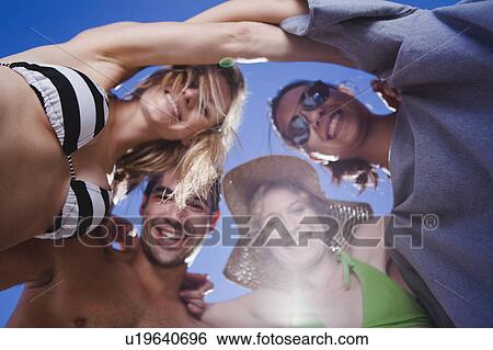 Friends hugging in a circle View Large Photo Image Stock Photograph - Friends hugging in a circle. Fotosearch