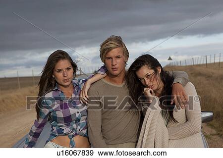 Friends in front of car View Large Photo Image Stock Photo - Friends in front of car. Fotosearch