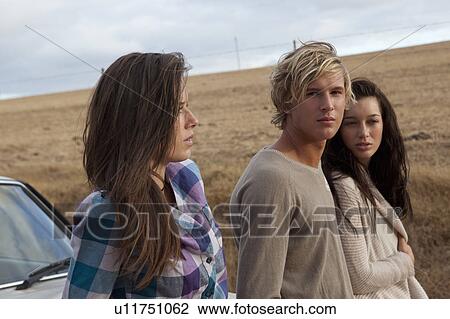 Friends leaning on car View Large Photo Image Stock Image - Friends leaning on car. Fotosearch