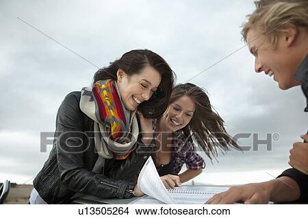 Picture - Friends looking in map. Fotosearch