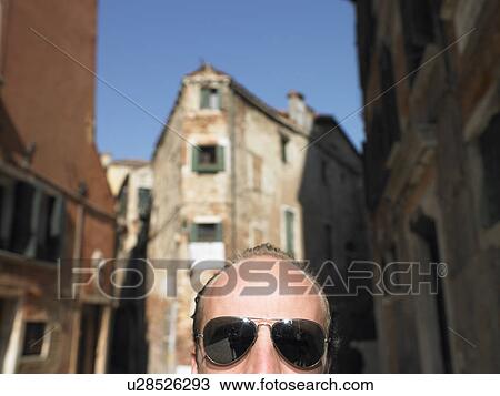 Stock Image - Front head of a man wearing sunglasses. Fotosearch