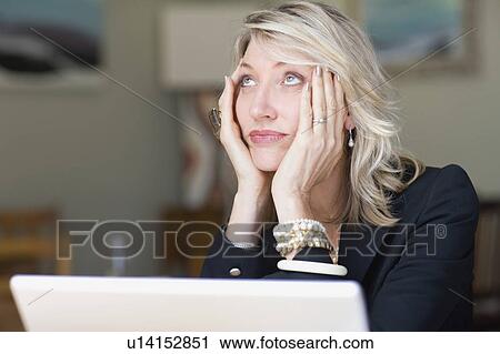 Frustrated businesswoman using laptop View Large Photo Image Stock Image - Frustrated businesswoman using laptop. Fotosearch