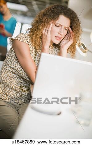 Frustrated businesswoman using laptop View Large Photo Image Stock Photo - Frustrated businesswoman using laptop. Fotosearch
