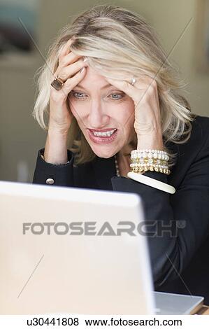 Frustrated businesswoman using laptop View Large Photo Image Stock Photo - Frustrated businesswoman using laptop. Fotosearch