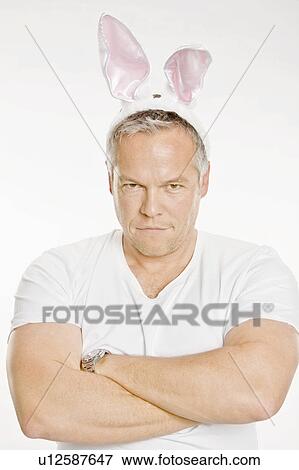 Frustrated man wearing bunny ears View Large Photo Image Stock Photo - Frustrated man wearing bunny ears. Fotosearch
