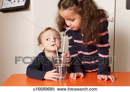 Girl and boy drinking water with straws View Large Photo Image Stock Photography - Girl and boy drinking water with straws. Fotosearch
